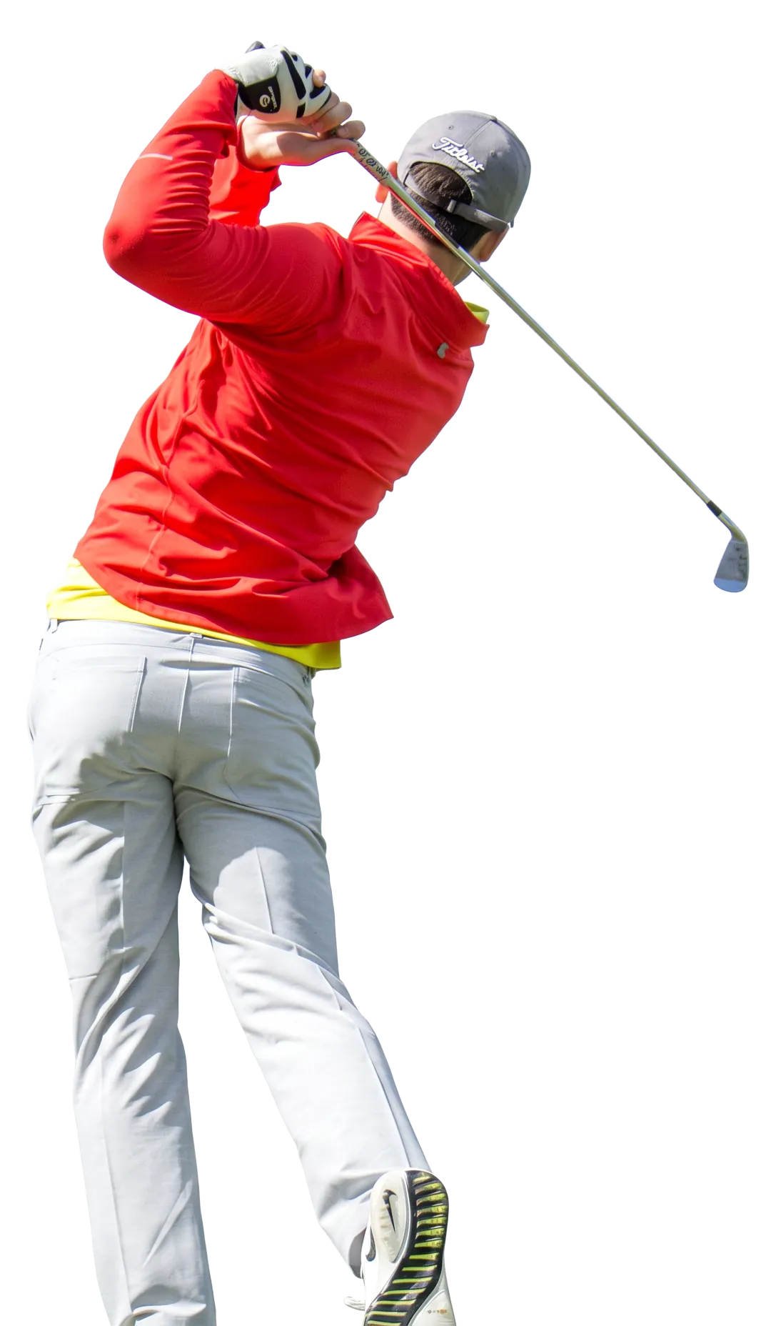 Golfer in a red pullover following through on a swing